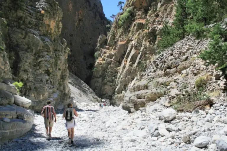 Two hikers on the stony path through the Samaria gorge, Crete.